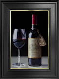 A bottle of Tony Owens red wine and a filled wine glass on a wooden surface, with the wine bottle label visible.